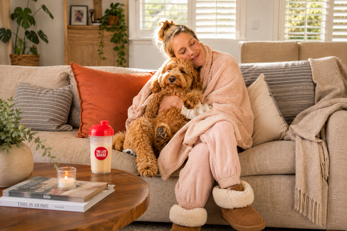 woman cozy in the couch with dog